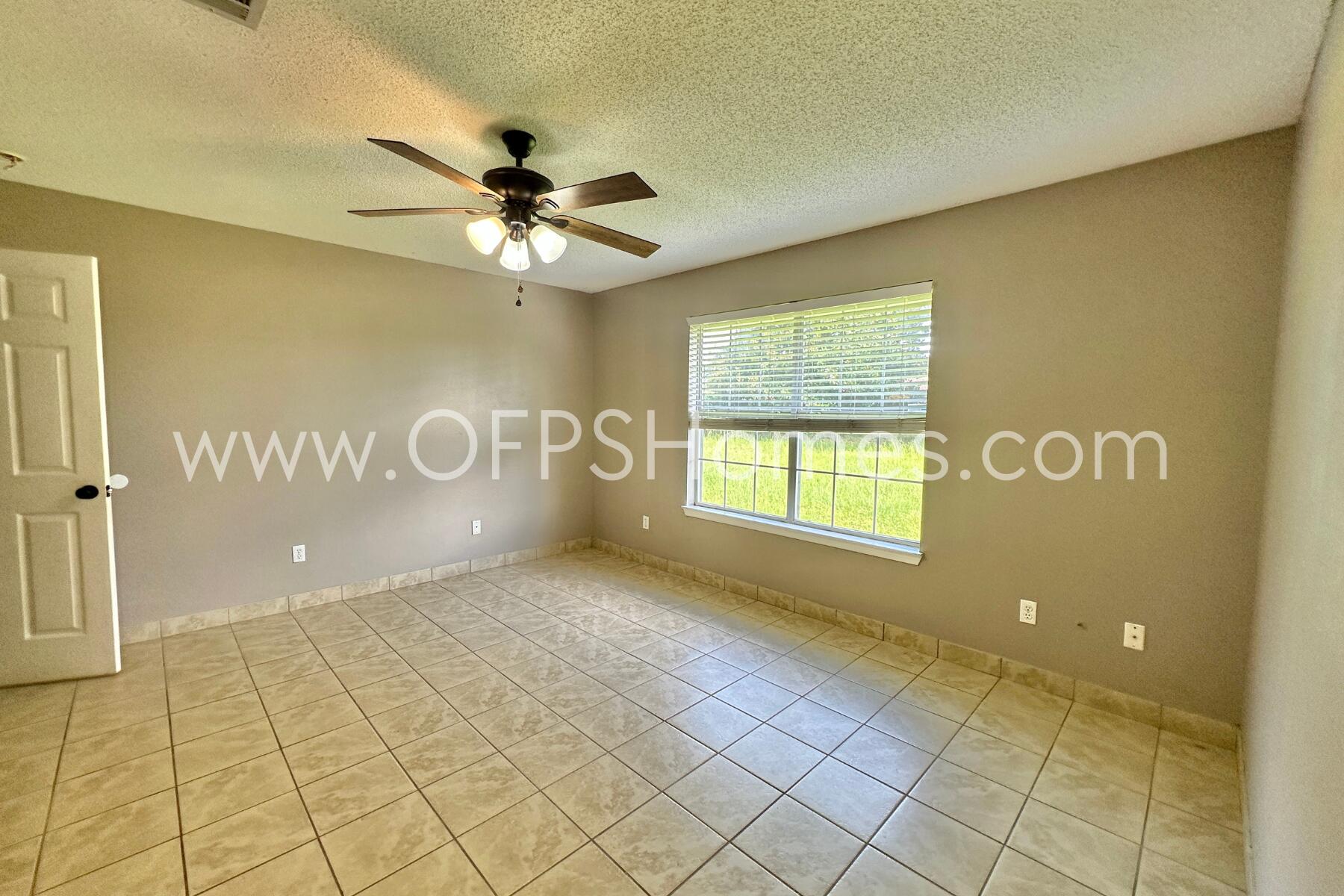 2837 Atoka Trail Crestview, FL 32539 - Photo 14 of 17 a view of a livingroom with a chandelier fan and windows