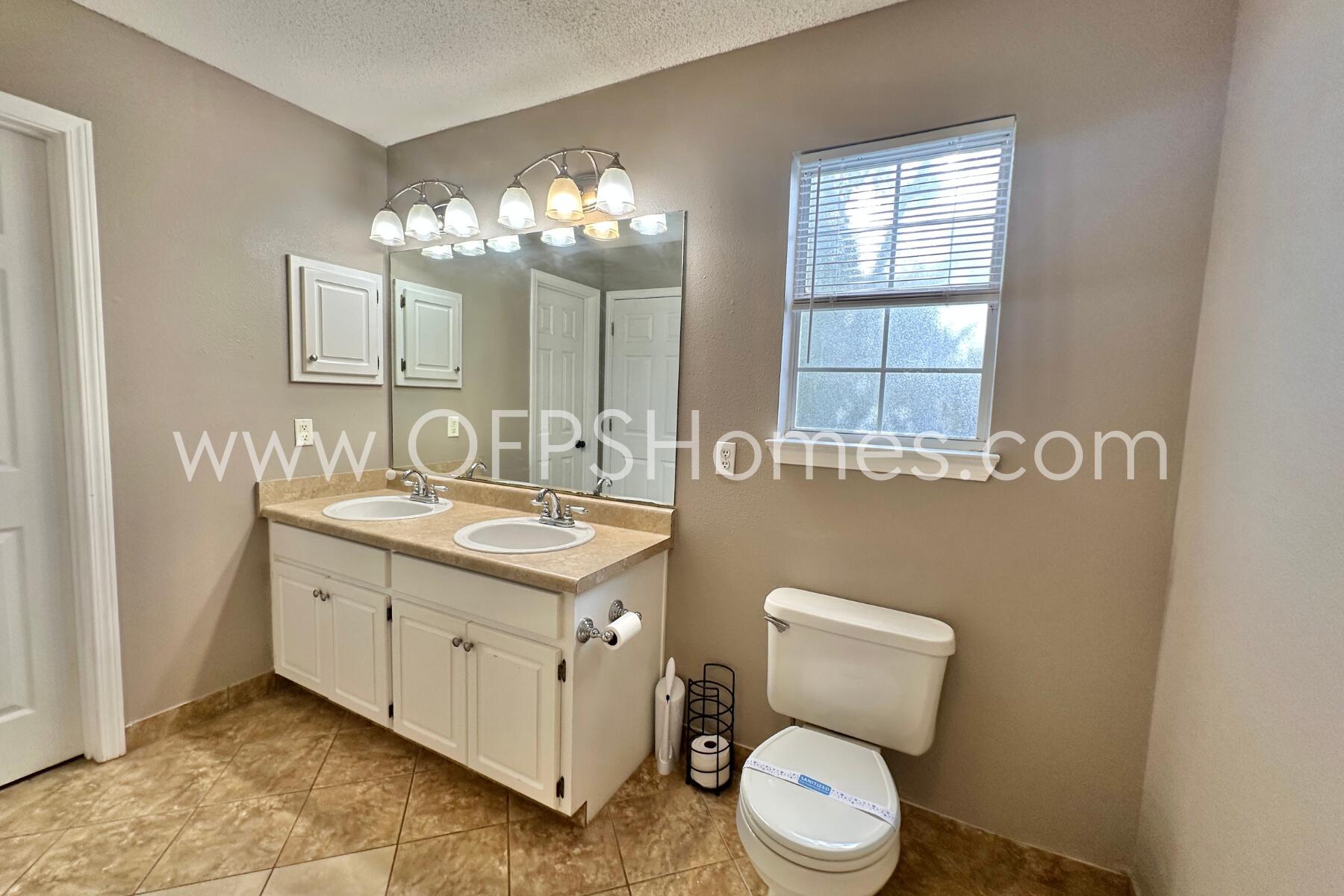 2837 Atoka Trail Crestview, FL 32539 - Photo 15 of 17 a bathroom with a toilet sink and mirror