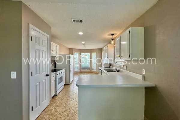 a kitchen with stainless steel appliances granite countertop a sink and refrigerator