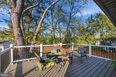 a view of deck with seating space and trees