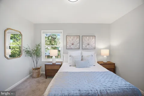 a bedroom with a large bed and a lamp