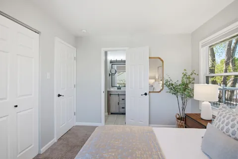 a bedroom with furniture and a potted plant