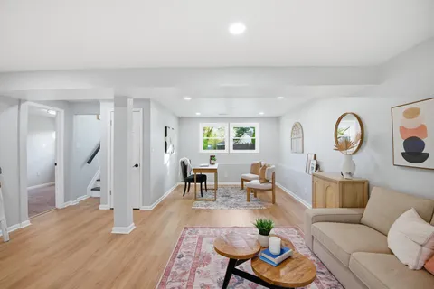 a living room with furniture and wooden floor
