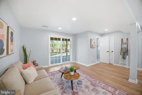 a living room with furniture a rug a lamp and a table