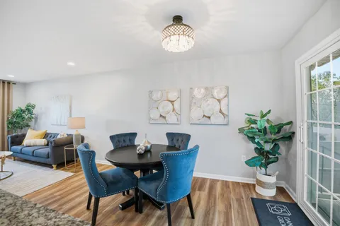 a view of a dining room with furniture and wooden floor