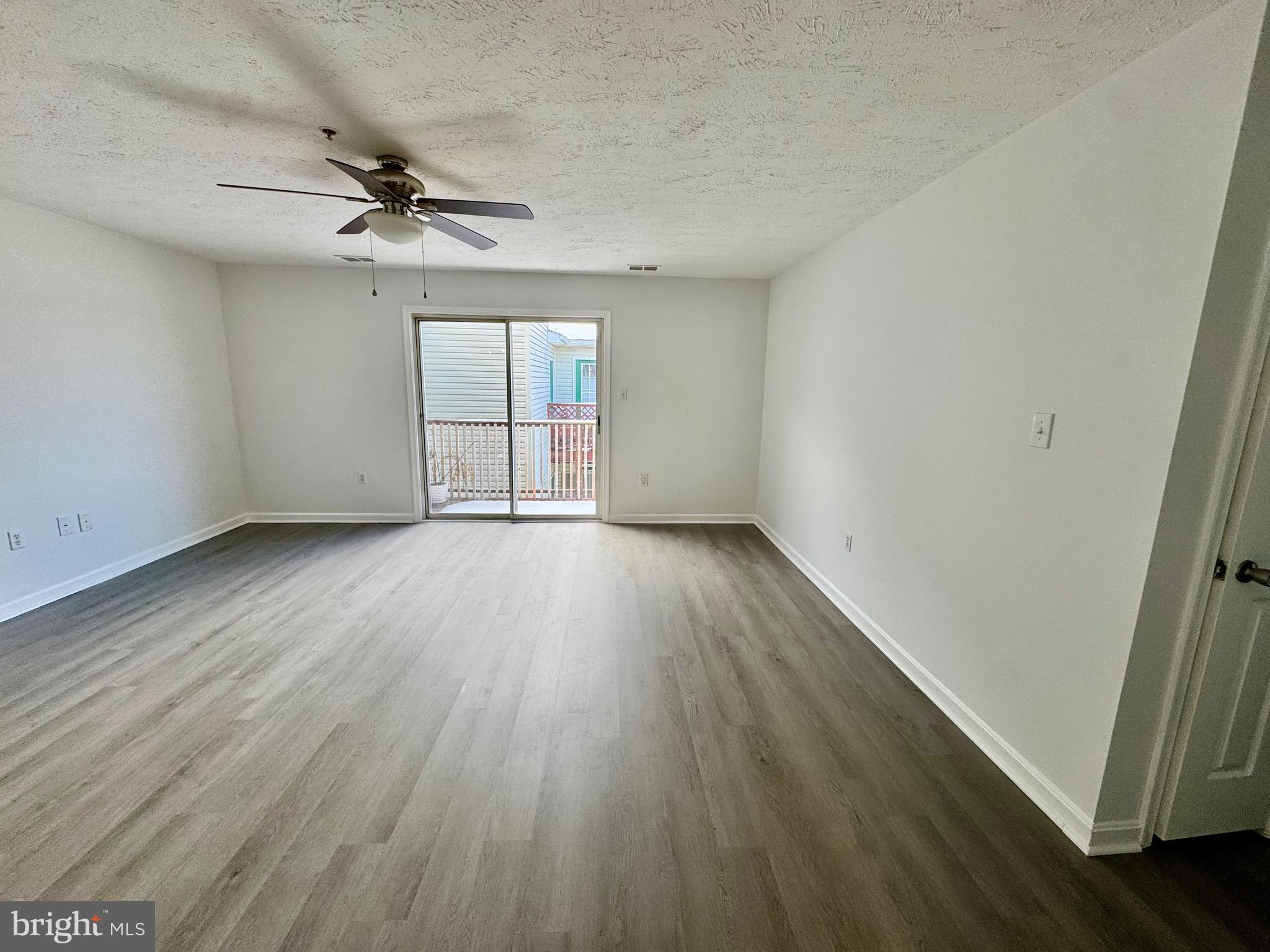 1290 South Ox Road Woodstock, VA 22664 - Photo 7 of 13 wooden floor in an empty room with a window
