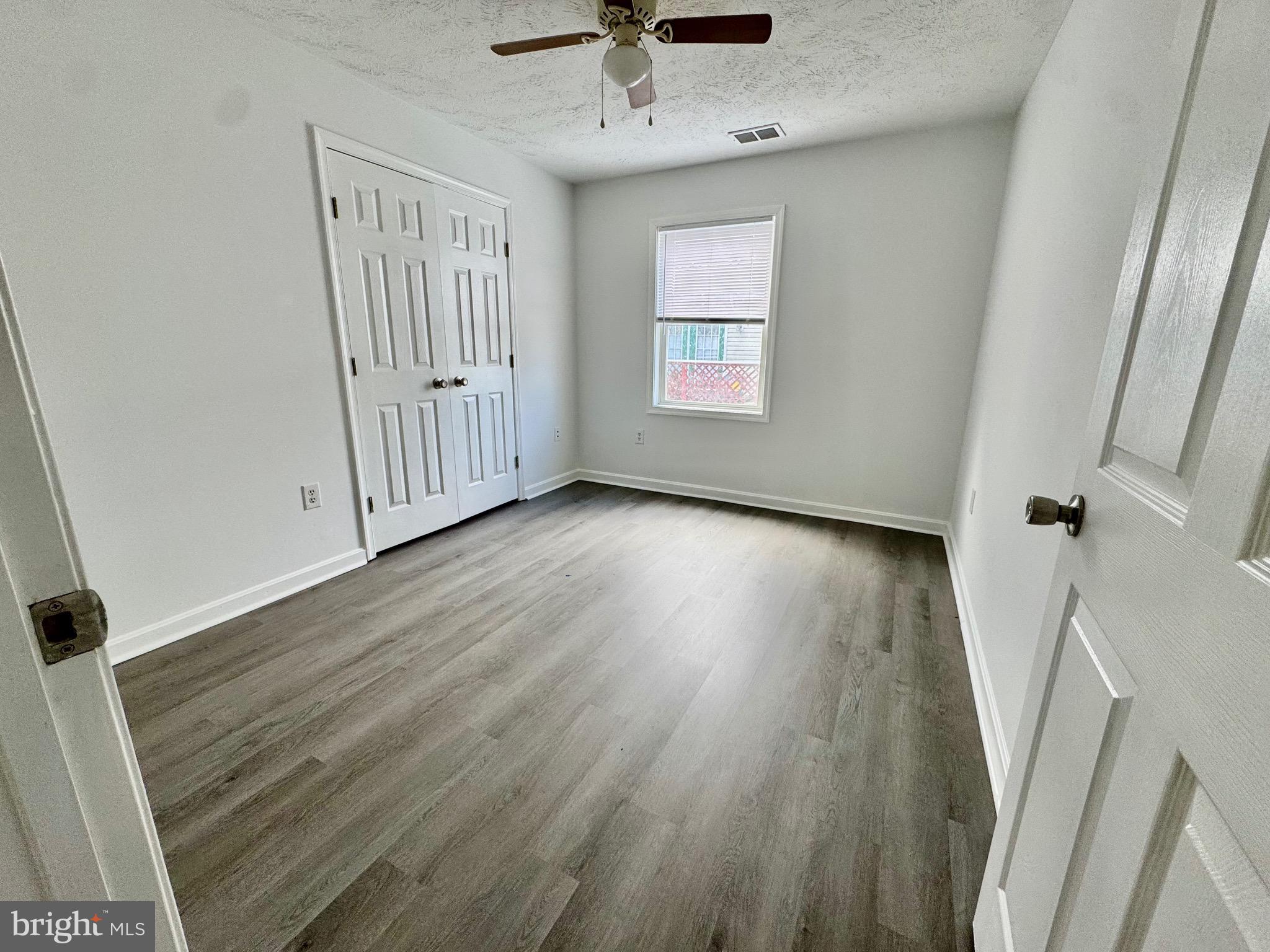 1290 South Ox Road Woodstock, VA 22664 - Photo 10 of 13 wooden floor in an empty room with a window