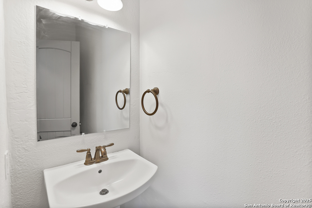 138 Perry Court, Unit 2 San Antonio, TX 78209 - Photo 11 of 29 a bathroom with a sink and mirror