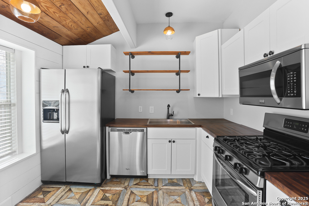 138 Perry Court, Unit 2 San Antonio, TX 78209 - Photo 13 of 29 a kitchen with stainless steel appliances a stove a sink and a refrigerator