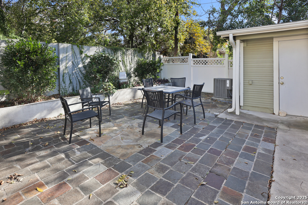 138 Perry Court, Unit 2 San Antonio, TX 78209 - Photo 27 of 29 a view of a patio with table and chairs and potted plants