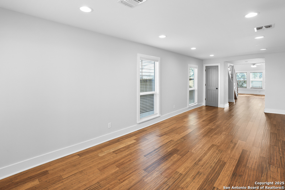138 Perry Court, Unit 2 San Antonio, TX 78209 - Photo 3 of 29 a view of an empty room with wooden floor and a window