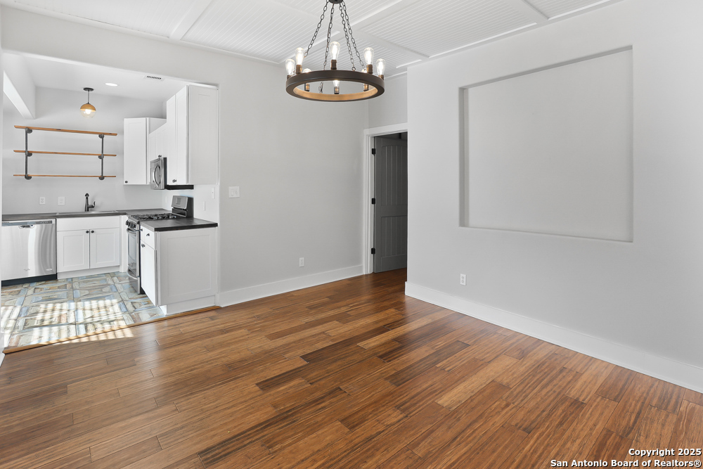138 Perry Court, Unit 2 San Antonio, TX 78209 - Photo 9 of 29 a view of a kitchen with wooden floor and a window