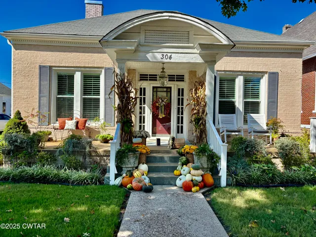 a front view of house with outdoor seating and garden