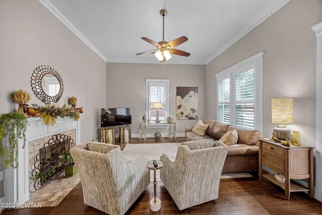 a living room with furniture a chandelier and a window
