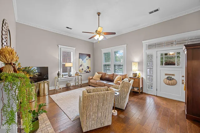 a living room with furniture a chandelier and a window