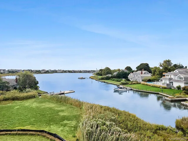 a view of a lake with houses in the back