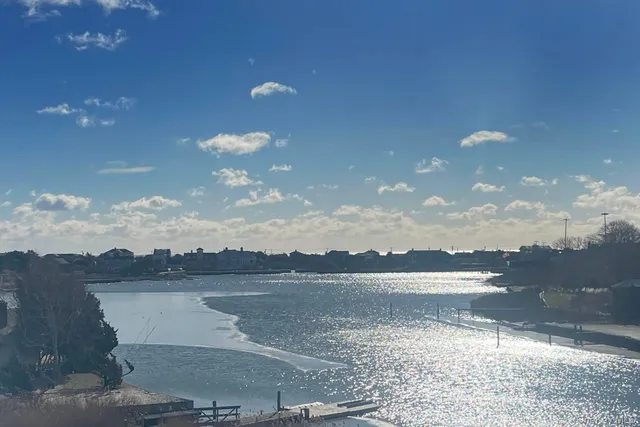 a view of a lake in middle of green field