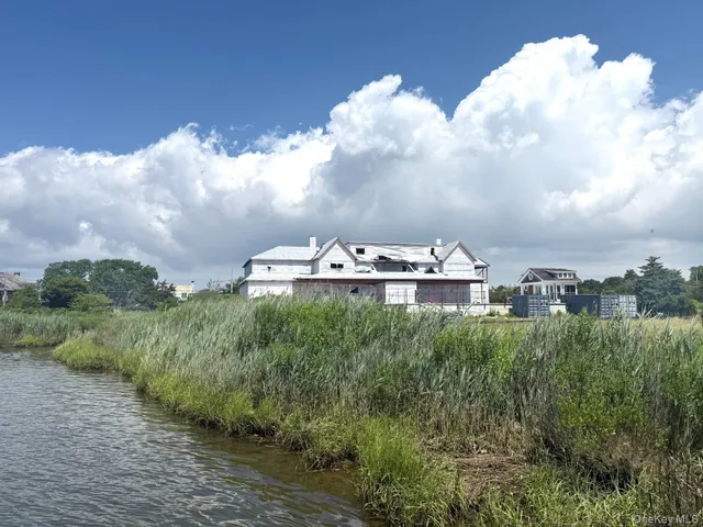 a view of a lake with houses in the back