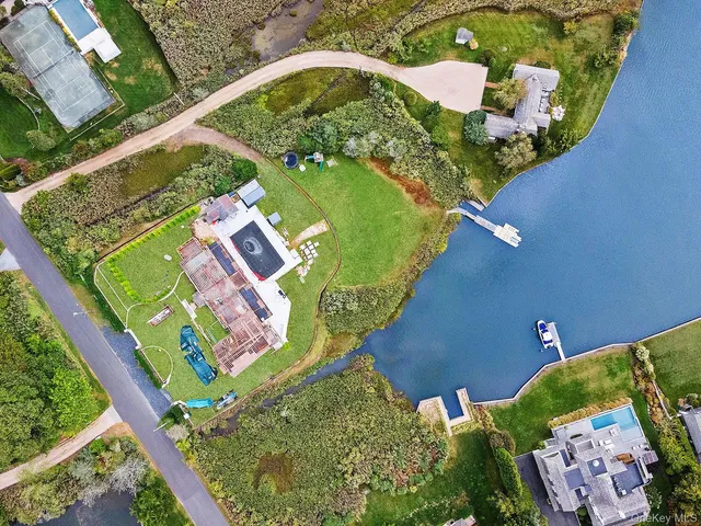 an aerial view of a residential houses with outdoor space