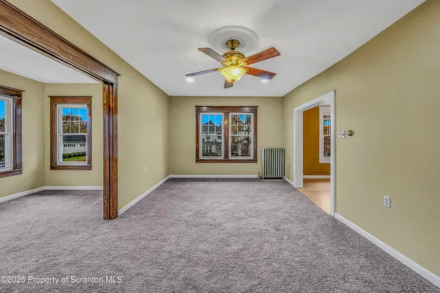 a view of a room with wooden floor closet and windows