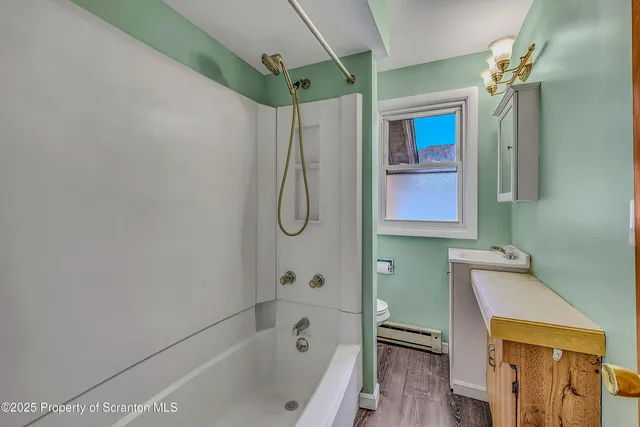 a bathroom with a shower a bath tub and a shower