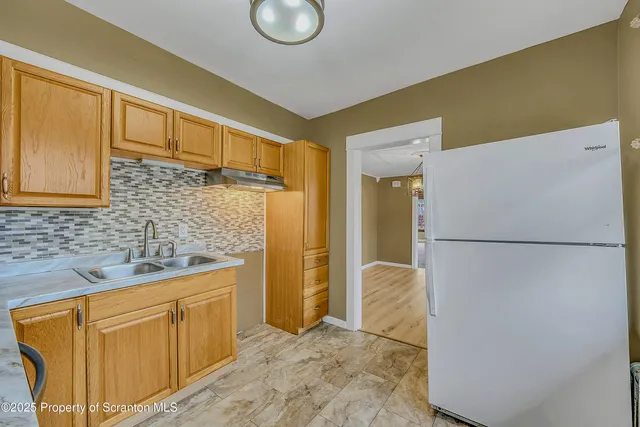 a view of a refrigerator and a sink