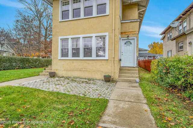 a view of a house with a yard and plants