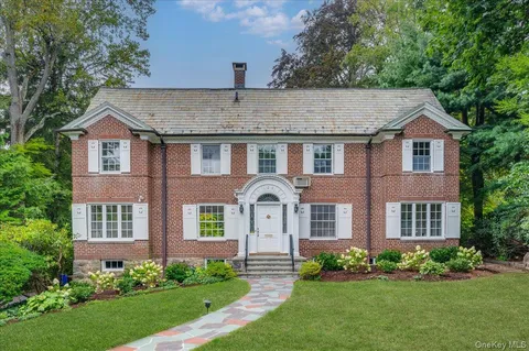 a front view of a house with a garden