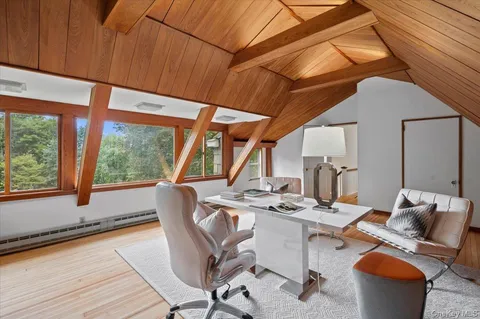 a dining room with furniture window and wooden floor