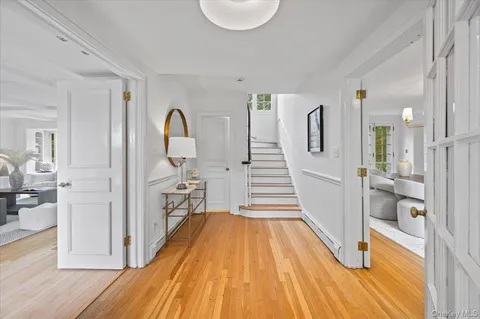 a view of a room with wooden floor and furniture