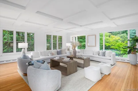 a living room with furniture and large windows