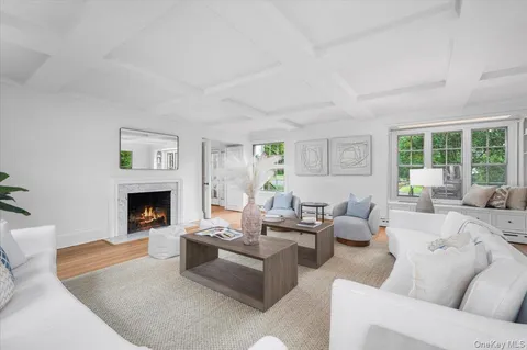 a living room with furniture a fireplace and a large window