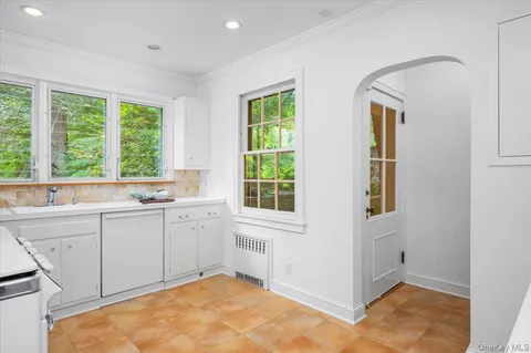 a spacious bathroom with windows and dual sinks