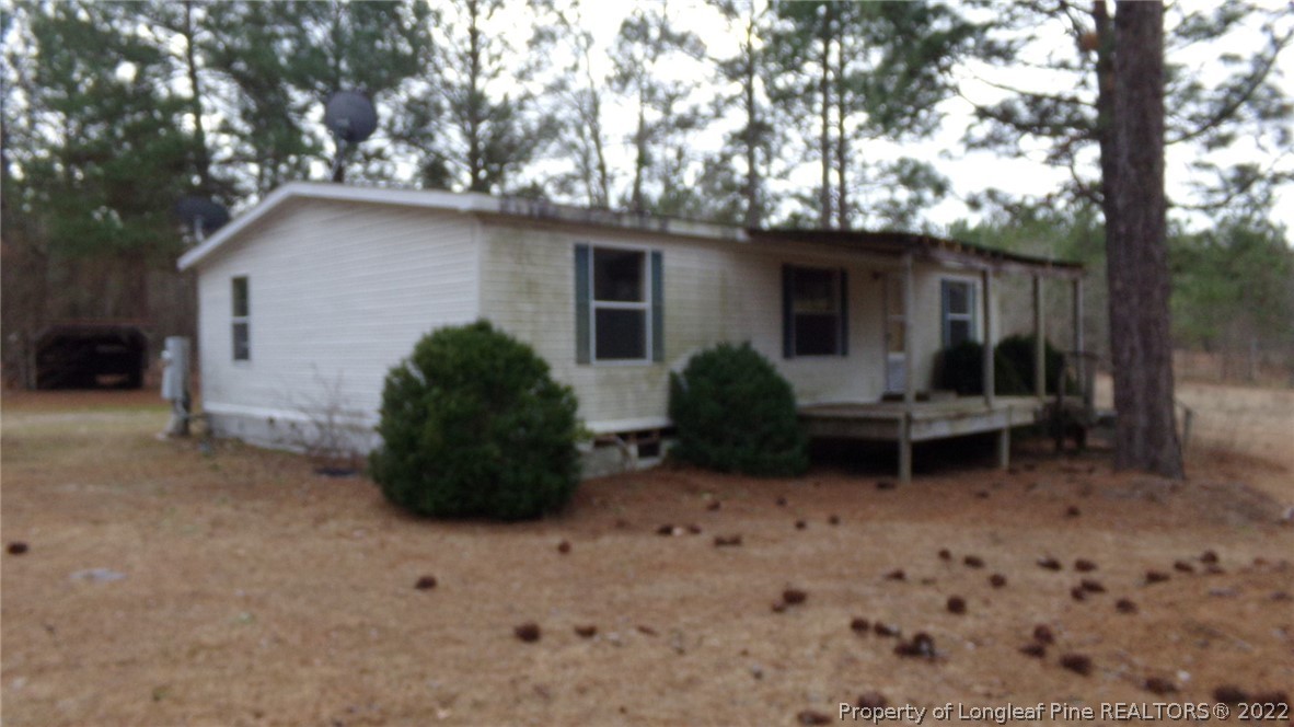 128 Dodson Road Rockingham, NC 28379 - Photo 1 of 25 a backyard of a house with barbeque oven and outdoor seating