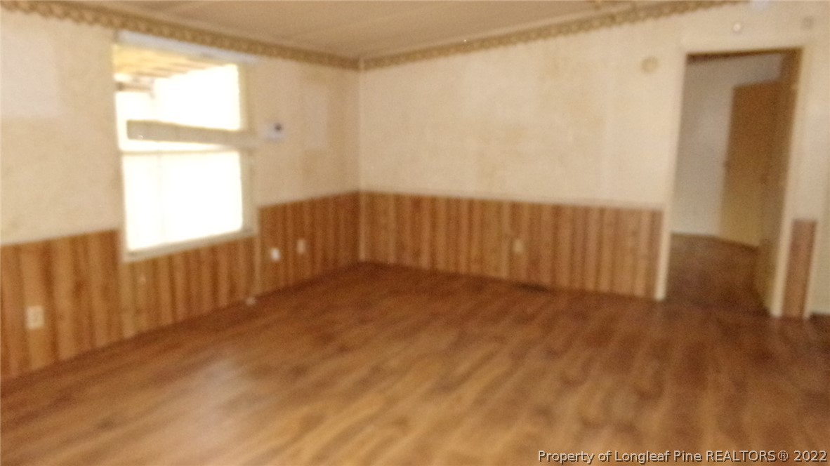 128 Dodson Road Rockingham, NC 28379 - Photo 23 of 25 a view of an empty room with wooden floor