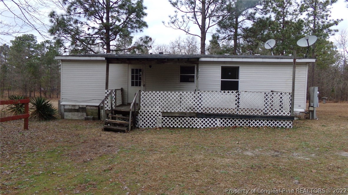 128 Dodson Road Rockingham, NC 28379 - Photo 3 of 25 a view of a house with a bed and a chair