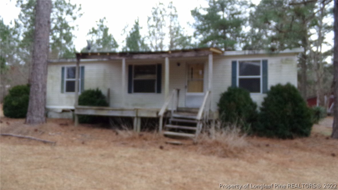 128 Dodson Road Rockingham, NC 28379 - Photo 7 of 25 a backyard of a house with table and chairs