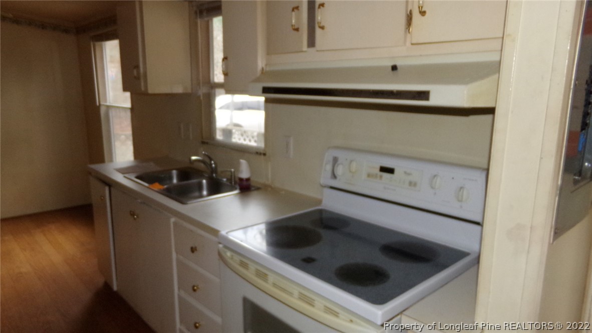 128 Dodson Road Rockingham, NC 28379 - Photo 10 of 25 a kitchen with a sink a stove and cabinets