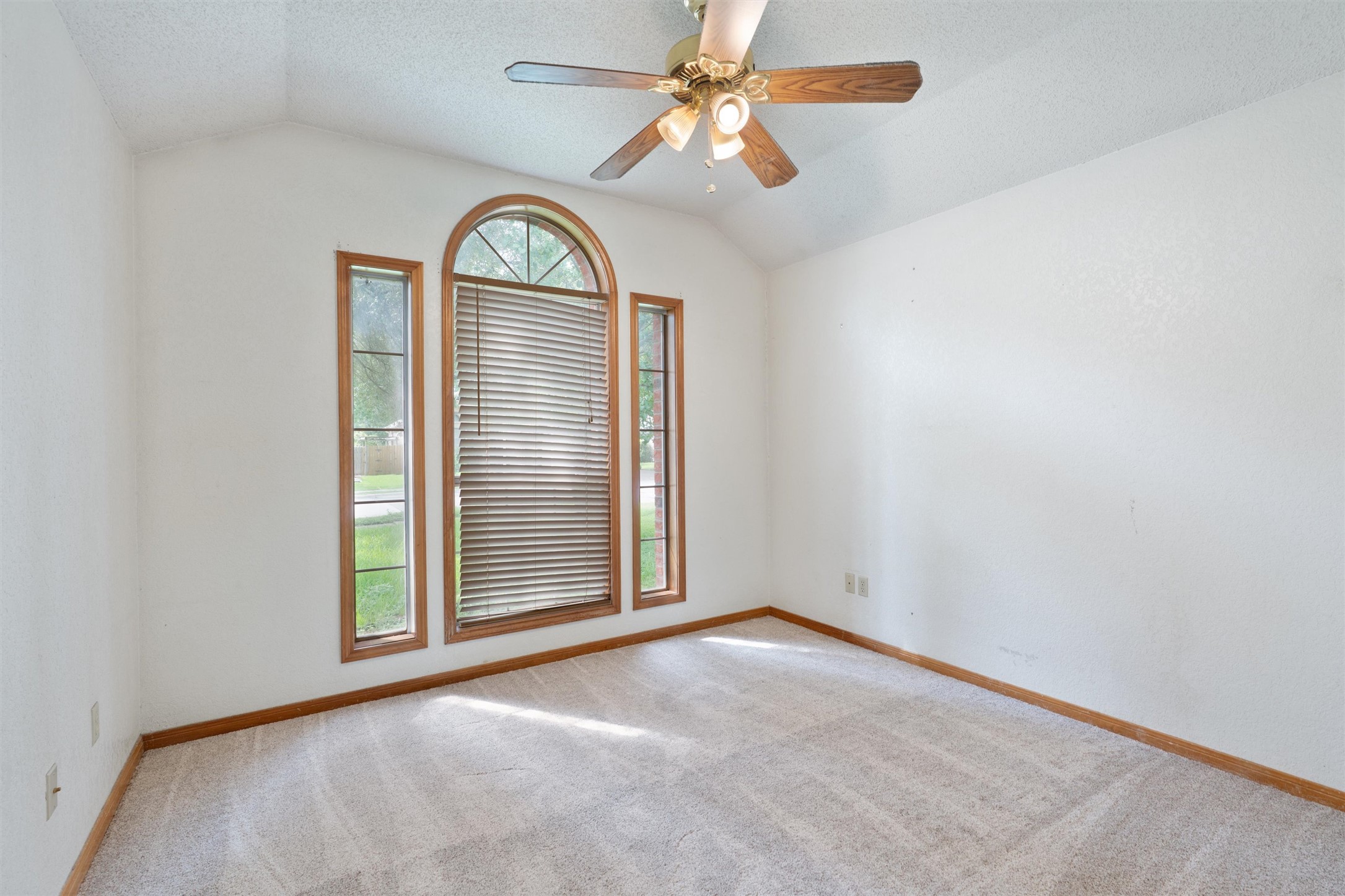 2306 Raintree Path Round Rock, TX 78664 - Photo 21 of 23 Voluminous ceilings elevate this naturally illuminated room, anchored by a stylish ceiling fan.