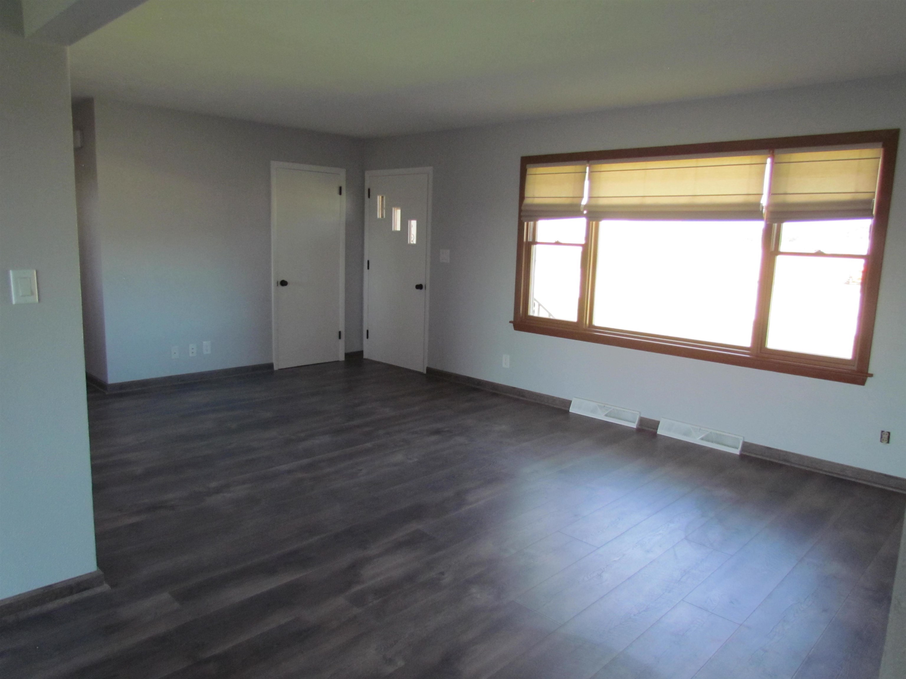 2475 North Pecatonica Road Pecatonica, IL 61063 - Photo 12 of 36 an empty room with wooden floor and windows