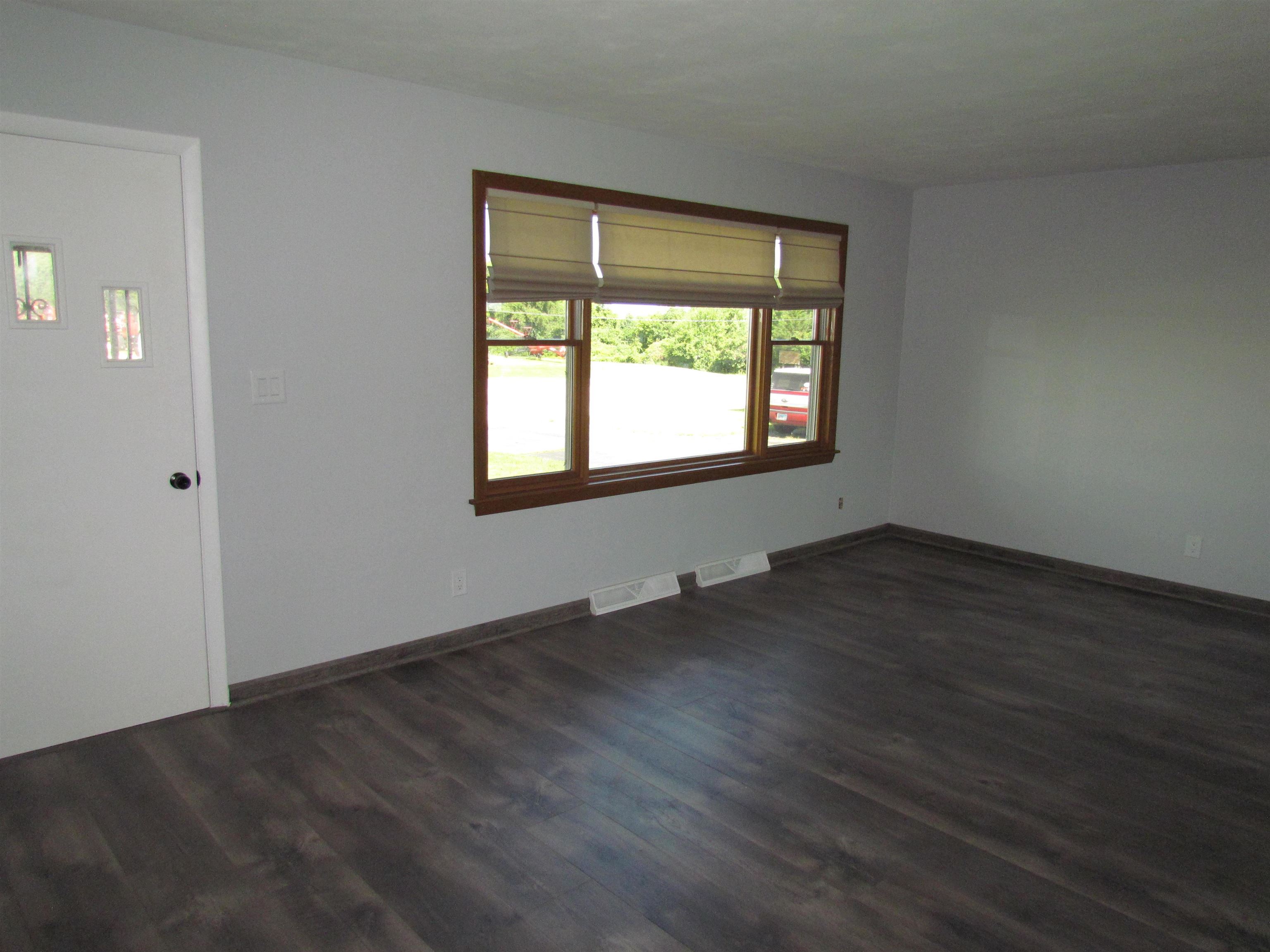 2475 North Pecatonica Road Pecatonica, IL 61063 - Photo 14 of 36 an empty room with wooden floor and windows