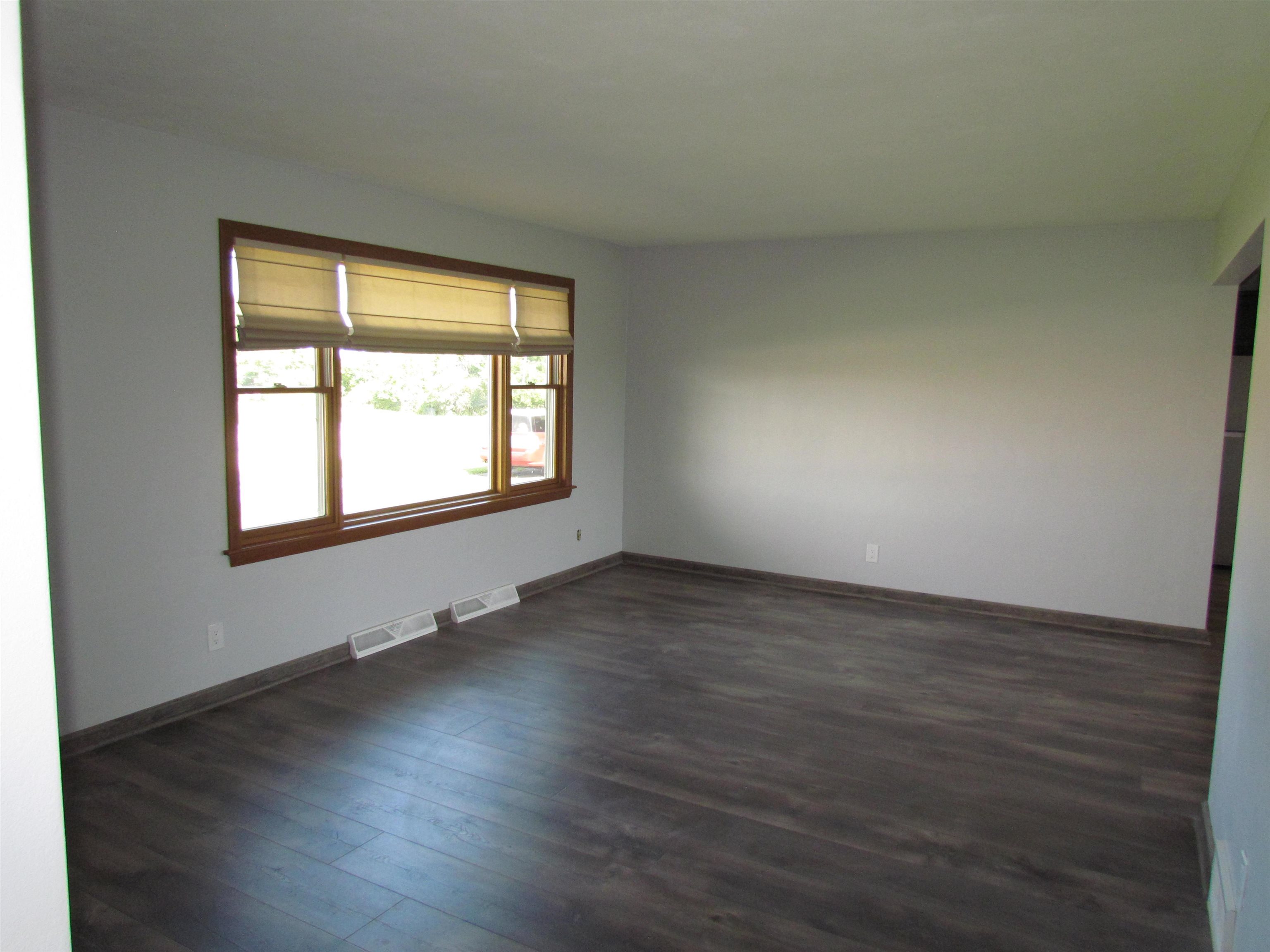 2475 North Pecatonica Road Pecatonica, IL 61063 - Photo 15 of 36 an empty room with wooden floor and windows
