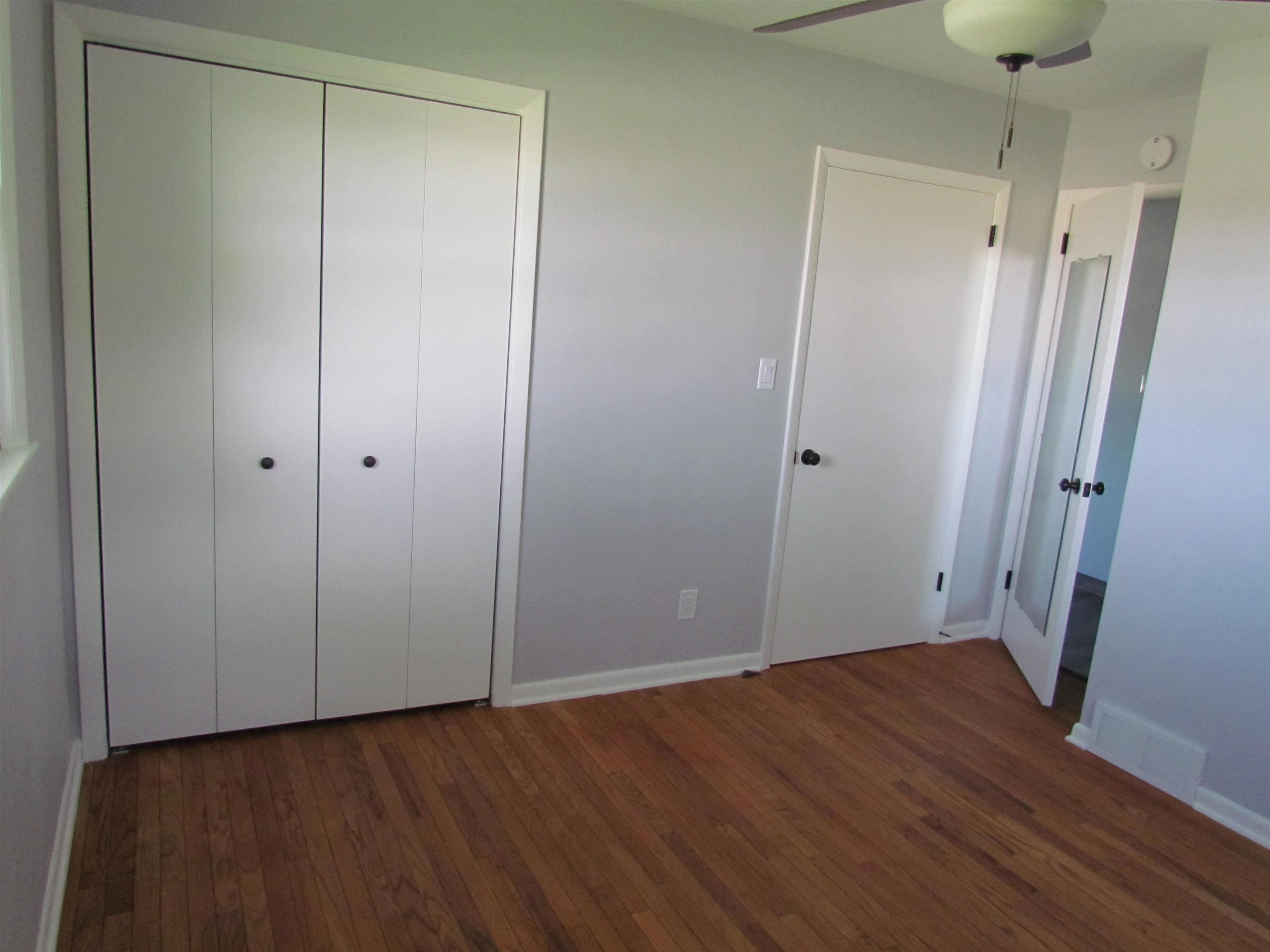 2475 North Pecatonica Road Pecatonica, IL 61063 - Photo 19 of 36 a view of an empty room with wooden floor