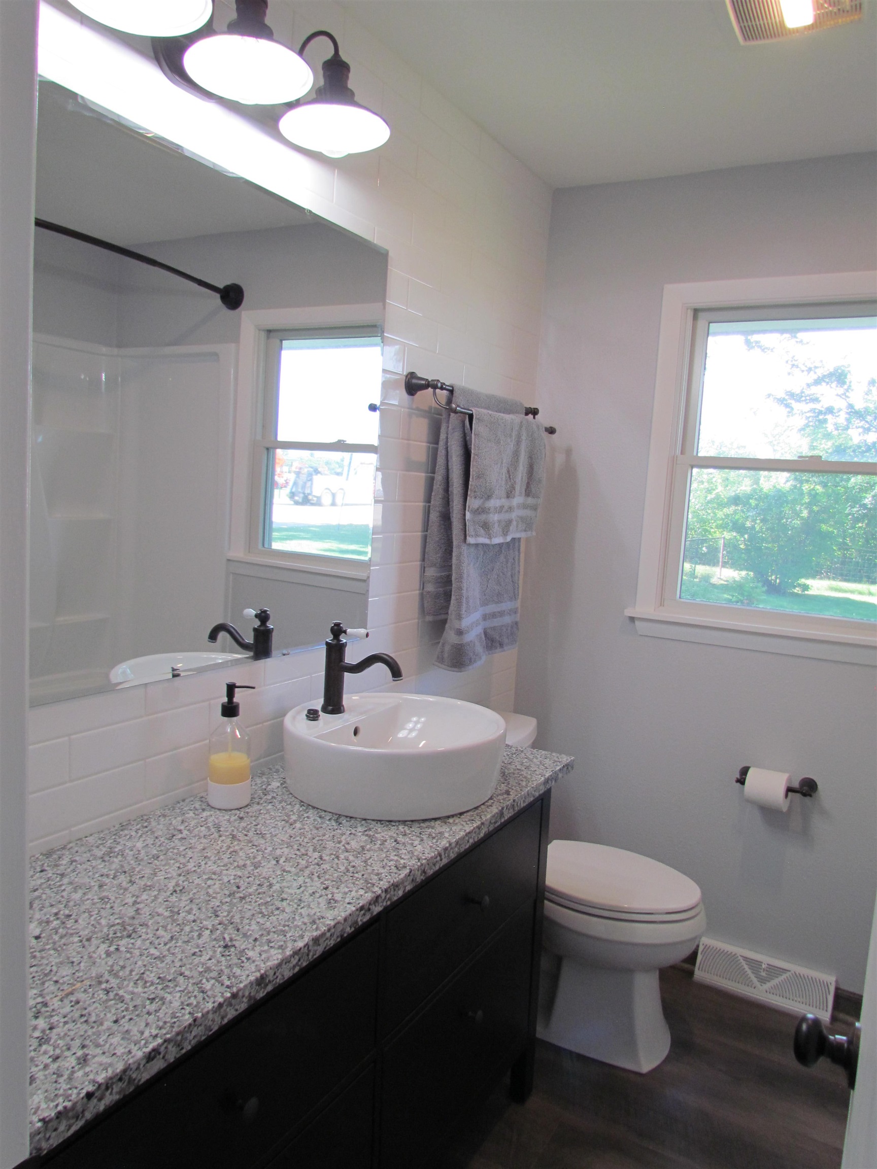 2475 North Pecatonica Road Pecatonica, IL 61063 - Photo 21 of 36 a bathroom with a double vanity sink toilet and a mirror