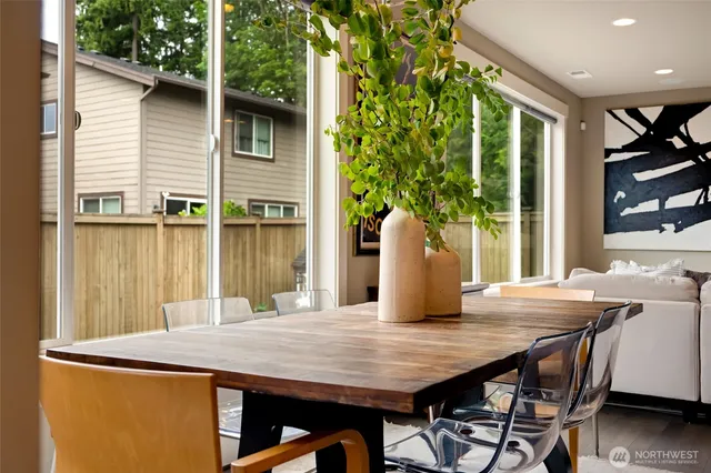 a view of a patio with table and chairs with wooden floor and plants