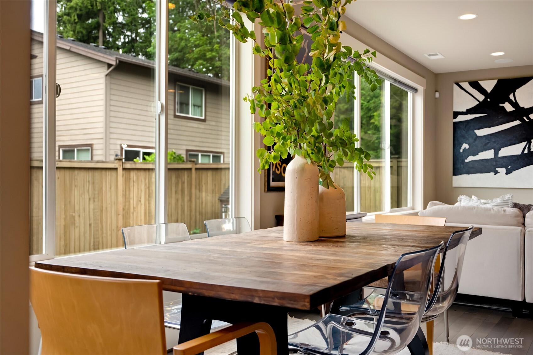619 Graham Avenue Northeast Renton, WA 98059 - Photo 11 of 40 a view of a patio with table and chairs with wooden floor and plants