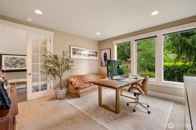 a living room with furniture a large window and a table
