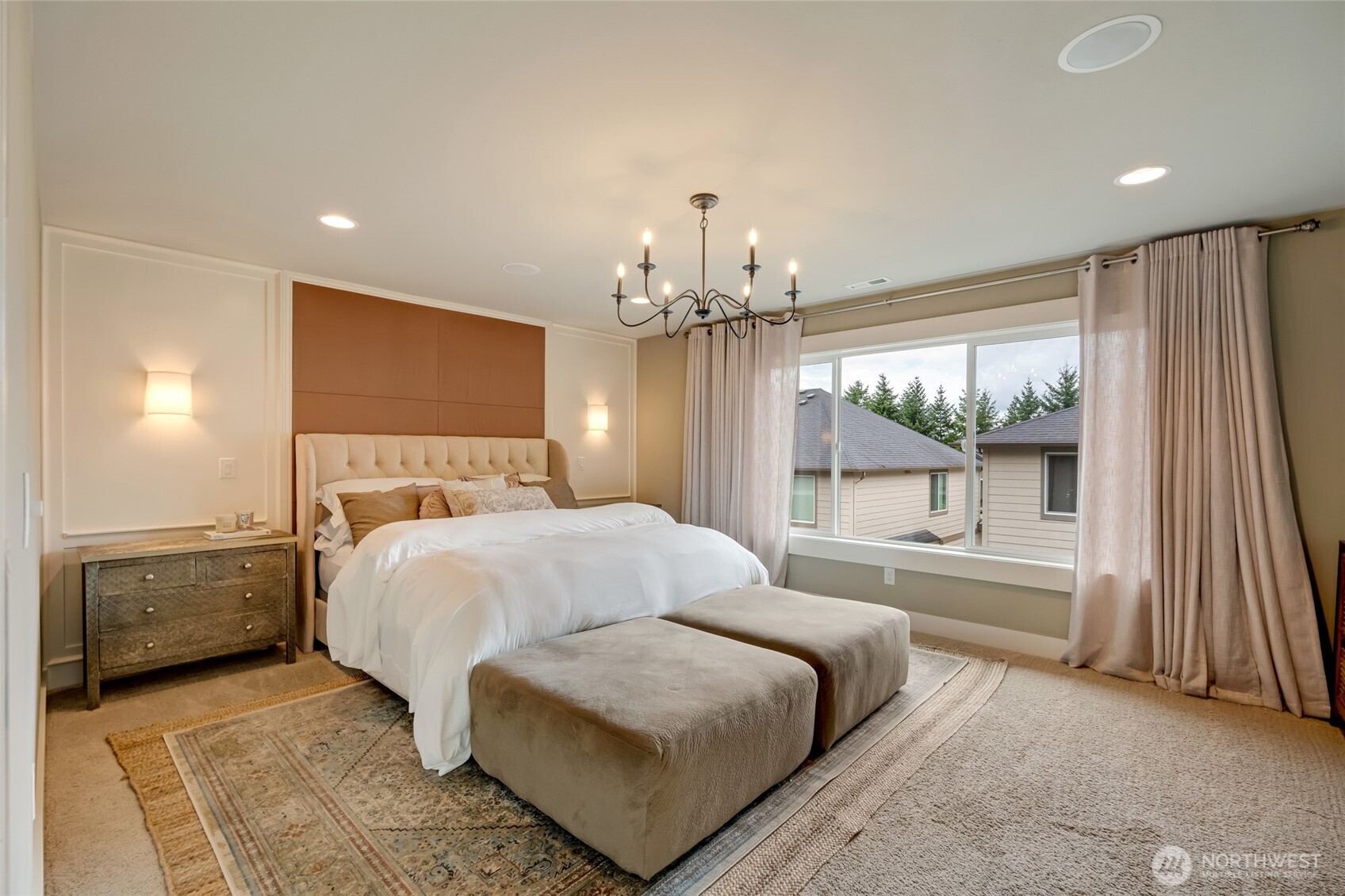 619 Graham Avenue Northeast Renton, WA 98059 - Photo 24 of 40 a spacious bedroom with a large bed and a chandelier