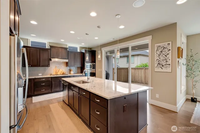 a kitchen with a stove a refrigerator and a sink
