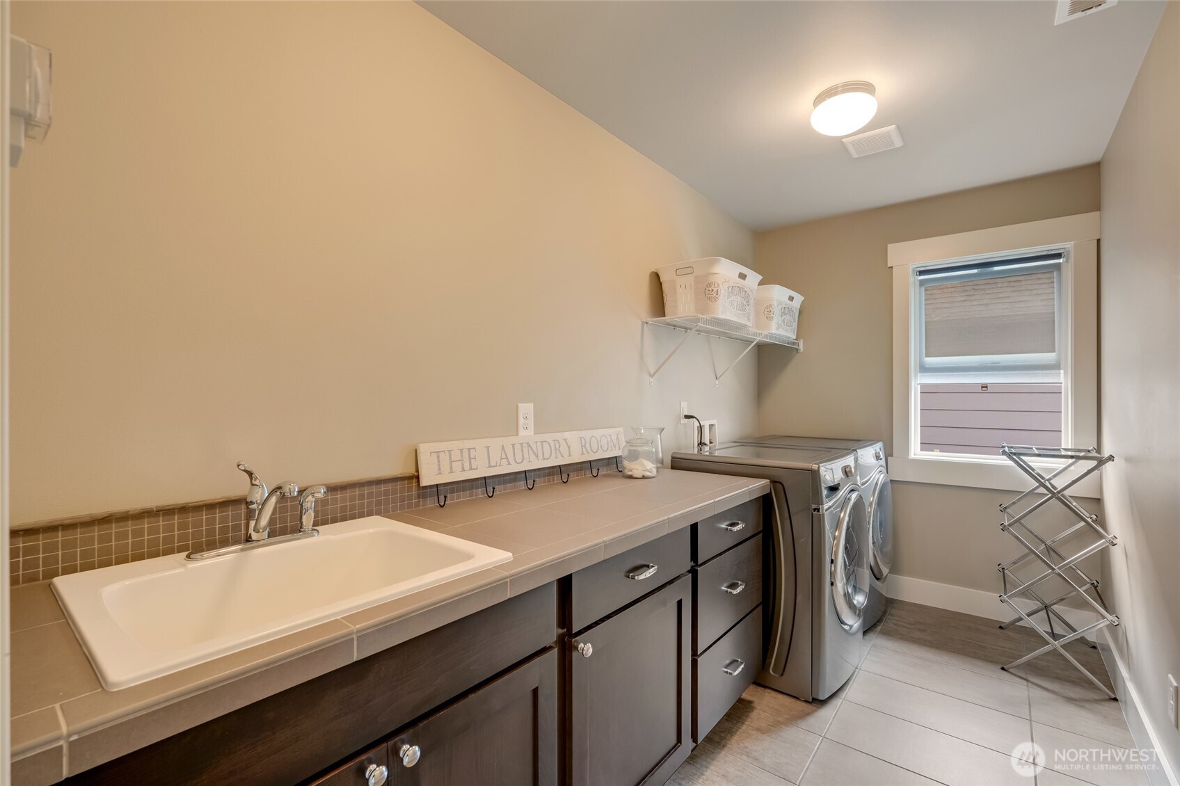 619 Graham Avenue Northeast Renton, WA 98059 - Photo 34 of 40 a kitchen with a sink cabinets and appliances